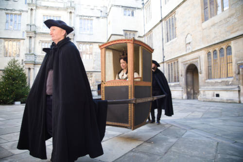Lucy Worsley being carried in Westminster Chair